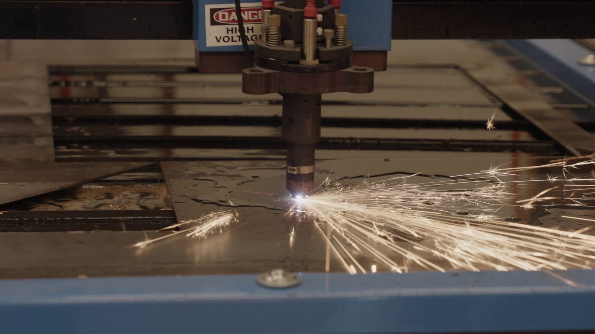 A CNC plasma cutter cutting steel plate in the Madison Highland Prep fabrication shop